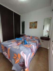 a bedroom with a large bed with a colorful blanket at Camba Cua Relax in Corrientes