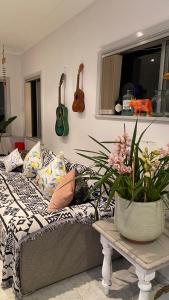 a room with a bed and a vase with flowers at Tranquil Garden view Room Macquiare Marsfield Eastwood in Sydney