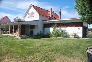 a white house with a red roof at Dora's Country Cottage in Escalante