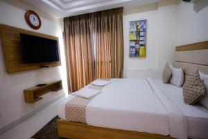 Postel nebo postele na pokoji v ubytování M Square Hotel