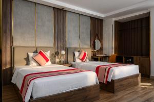 Postel nebo postele na pokoji v ubytování Acnos Hotel