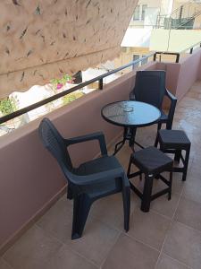 a table and chairs sitting on a balcony at EVITA apartment in Preveza