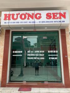 a person standing in the window of a store at Hương Sen Hotel in Ha Long