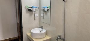 a bathroom with a sink and a mirror at Hương Sen Hotel in Ha Long