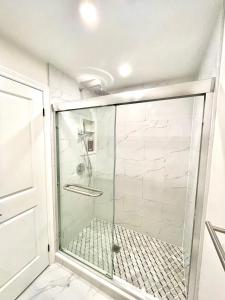 a shower with a glass door in a bathroom at New 3 Bedroom Bungalow Ground Floor with BBQ Patio in Richmond Hill +26 photos