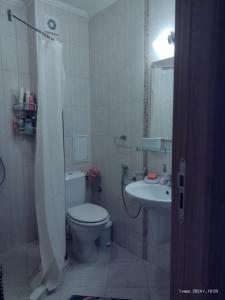 a bathroom with a toilet and a sink at Messembria Palace Bulgaria in Sunny Beach +24 photos