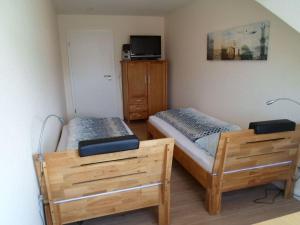 a bedroom with two beds and a dresser at Flotsam and jetsam Modern retreat in Kühlungsborn