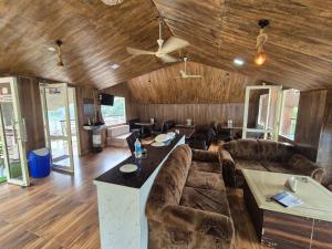 a living room with a couch and a table at Da Shack in Mandi