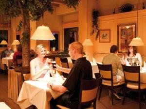 a group of people sitting at a table in a restaurant at Mobile home Chatel 'Hotelzimmer' in Fehmarn +18 photos
