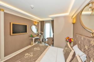 a hotel room with a bed and a tv at Hotel The Pera Hill in Istanbul