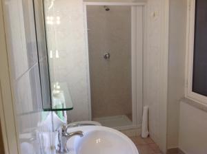 a bathroom with a sink and a toilet and a shower at Albergo Cavour in Palermo