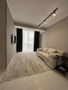 a bedroom with a bed and a large window at Sholpan city comfort in Almaty