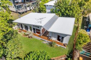 an aerial view of a house with a white roof at Straddie Glasshouse by Discover Stradbroke in Point Lookout