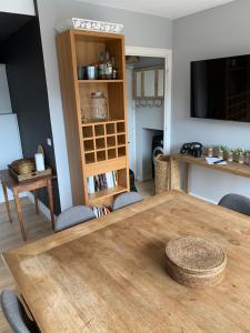 a dining room with a wooden table and chairs at La Musardiere in La Baule