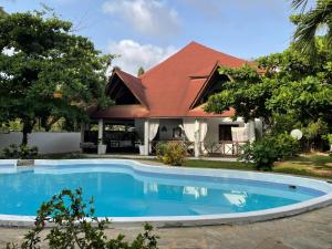 a house with a swimming pool in front of it at Nyumba Malaika in Malindi