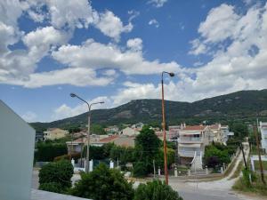 a view of a city with mountains and street lights at Blue Bay Hotel in Iraklitsa
