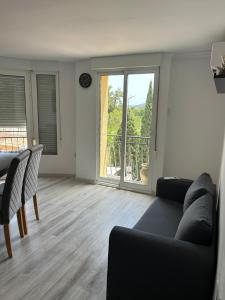 a living room with a couch and a large window at Gandia Borjia in Gandía