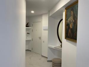 a hallway with white walls and a painting on the wall at Gandia Borjia in Gandía +6 photos