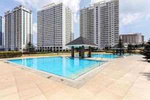 a large swimming pool with a gazebo in front of tall buildings at Cagayan De Oro house in Cagayan de Oro +21 photos