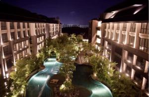 an overhead view of a courtyard with a pool inbetween two buildings at Anagata Tanjung Benoa Bali in Nusa Dua