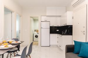 a kitchen and living room with a table and chairs at Sea Paradise in Pefkochori