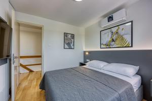 a bedroom with a bed in a room at Breeze Holiday Home - Sea View in Premantura +39 photos