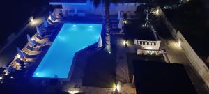 an overhead view of a swimming pool at night at Blue Bay Hotel in Iraklitsa