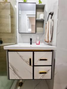 a bathroom with a sink and a mirror at 2BR Condo Unit in Camella Northpoint Bajada in Davao City