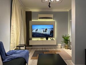 a living room with a flat screen tv on a wall at شقة قباء r s 1 in Medina