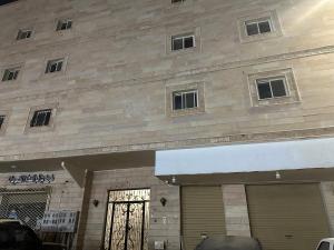 a building with a gate in front of it at شقة قباء r s 1 in Medina