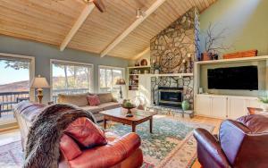 a living room with a couch and a fireplace at Vista Haven - Mountain Views and Fireplace and Big Screen TVs and Extras in Jasper