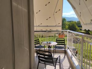 a balcony with a table and chairs and a view at Katerina & Despoinas Apartments in Paralia Panteleimonos