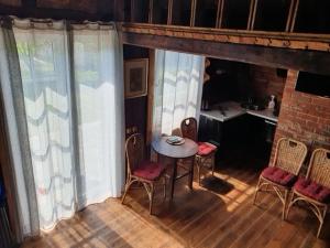 a room with a table and chairs and a kitchen at Auci Guest house 2 in Liepāja