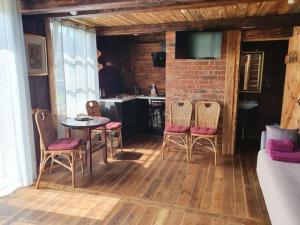 a room with a table and chairs and a kitchen at Auci Guest house 2 in Liepāja