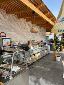 a restaurant with a buffet line with food at Ilio Boutique Hotel in Ksamil