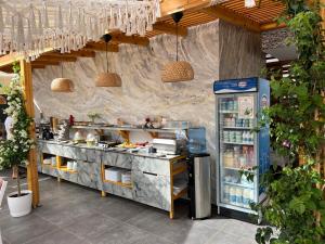 a kitchen with a counter with a refrigerator at Ilio Boutique Hotel in Ksamil