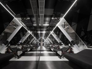 a gym with a row of treadmills at ISEYA Panoramic Hotel Chongqing Jiefangbei Raffles Plaza in Chongqing