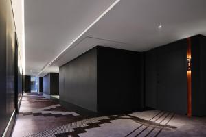a hallway with black walls and a white ceiling at ISEYA Panoramic Hotel Chongqing Jiefangbei Raffles Plaza in Chongqing