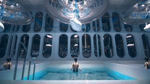a man standing in a bath tub in a room at ISEYA Panoramic Hotel Chongqing Jiefangbei Raffles Plaza in Chongqing