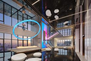 a lobby with white stools in a building at ISEYA Panoramic Hotel Chongqing Jiefangbei Raffles Plaza in Chongqing
