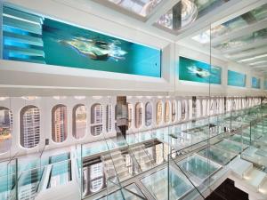 a glass staircase in a building with a glass floor at ISEYA Panoramic Hotel Chongqing Jiefangbei Raffles Plaza in Chongqing