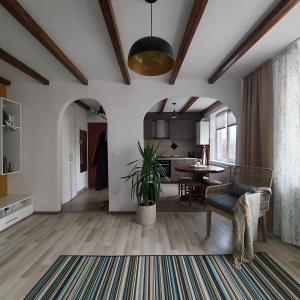a living room with a table and a dining room at Apartment next to castle park in Carei