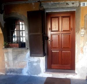 a red door on the side of a building at La Marmotta in Luserna San Giovanni