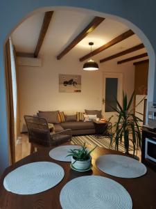 a living room with a table with four plates on it at Apartment next to castle park in Carei