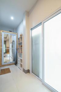 a room with a sliding glass door and a mirror at Sunset beach apartment 12 O3 villas in Koh Phangan +55 photos