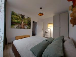 a bedroom with a large bed and a couch at Apartment next to castle park in Carei +5 photos
