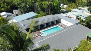 an aerial view of a house with a swimming pool at Hakuna Maldives in Thoddoo