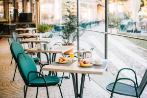 a restaurant with tables and chairs with food on them at Arciduca Charming House Room & Breakfast in Arco