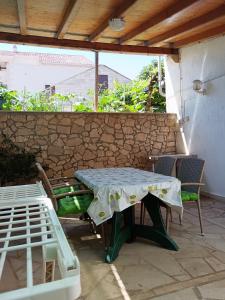 a table and chairs sitting on a patio at Apartments Villa Vanja in Povlja