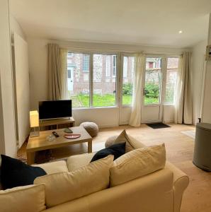 a living room with a couch and a large window at Le Refuge Marin in Dieppe